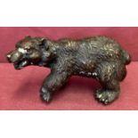 A small bronze figure of a bear.