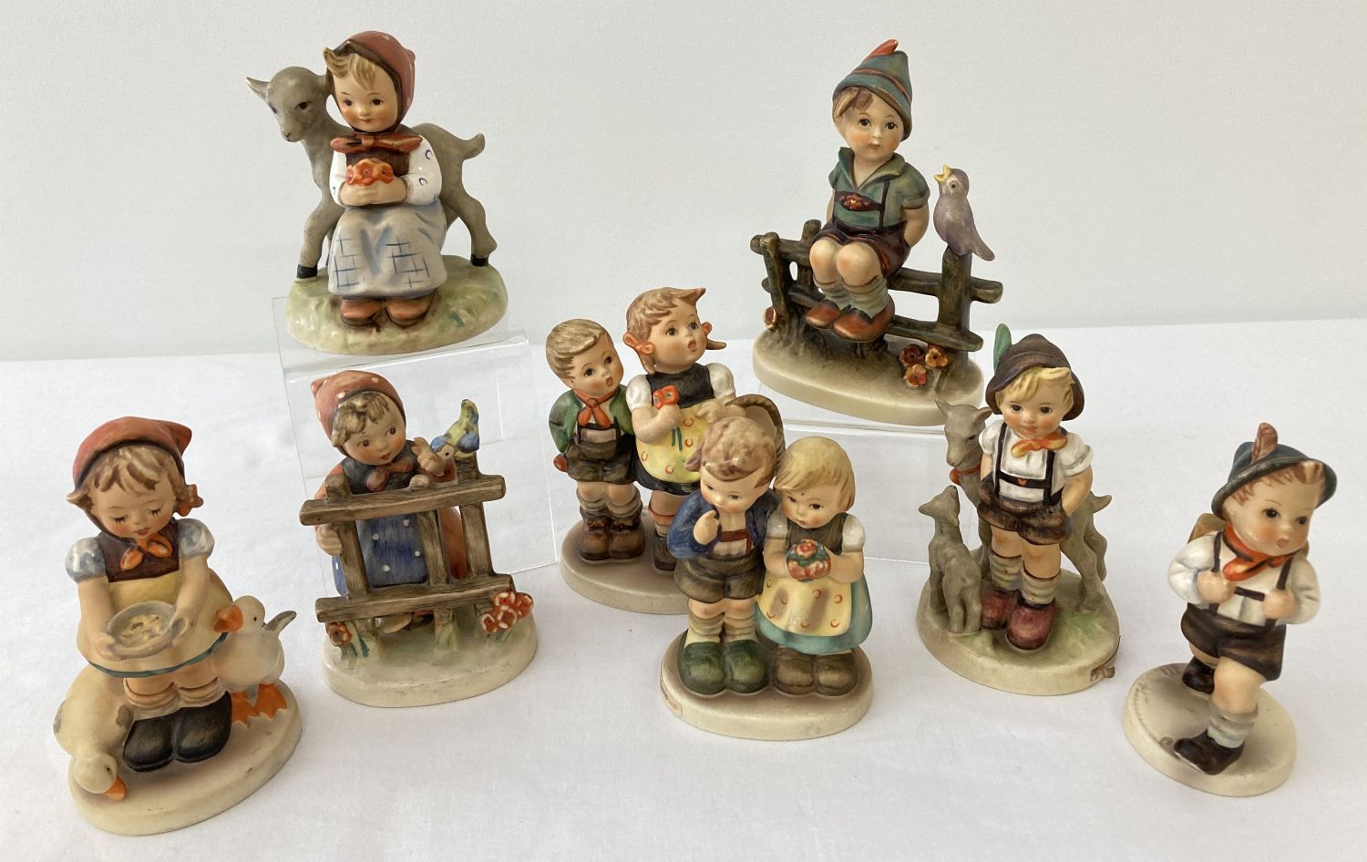 8 West German Goebel ceramic Hummel figurines.