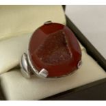 A contemporary design silver dress ring set with carnelian druzy.