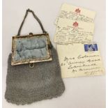 A vintage silver thread evening bag with floral patterned blue satin lining and chain handle.
