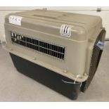 A large Vari-Kennel Ultra dog/pet plastic and metal transportation crate.