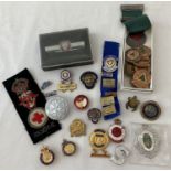 A collection of assorted vintage badges and medals.