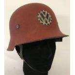 A German WWII style VW factory fireman's lightweight helmet and liner with leather straps.
