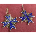 2 reproduction Pour Le Merite medals with blue enamel finish and eagle detail.