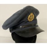 A 1962 RAF peaked cap with cap badge by J. Collett Ltd. With war arrow to inside rim.