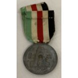 A WWII style Italian - German campaign medal on ribbon.