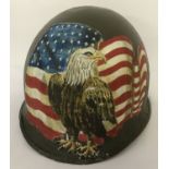 A WWII style US M1 front seam helmet with post war hand painted memorial decoration.