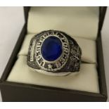 A Vietnam War style US Special Forces ring set with central blue stone.