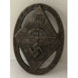 A German WWII style N.S.F.K Flying competition participation pin back badge.