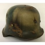 A German WWII style M42 Normandy helmet with painted camo detail.
