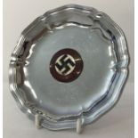 A German WWII style coin tray/ashtray with enamelled N.S.D.A.P party badge.