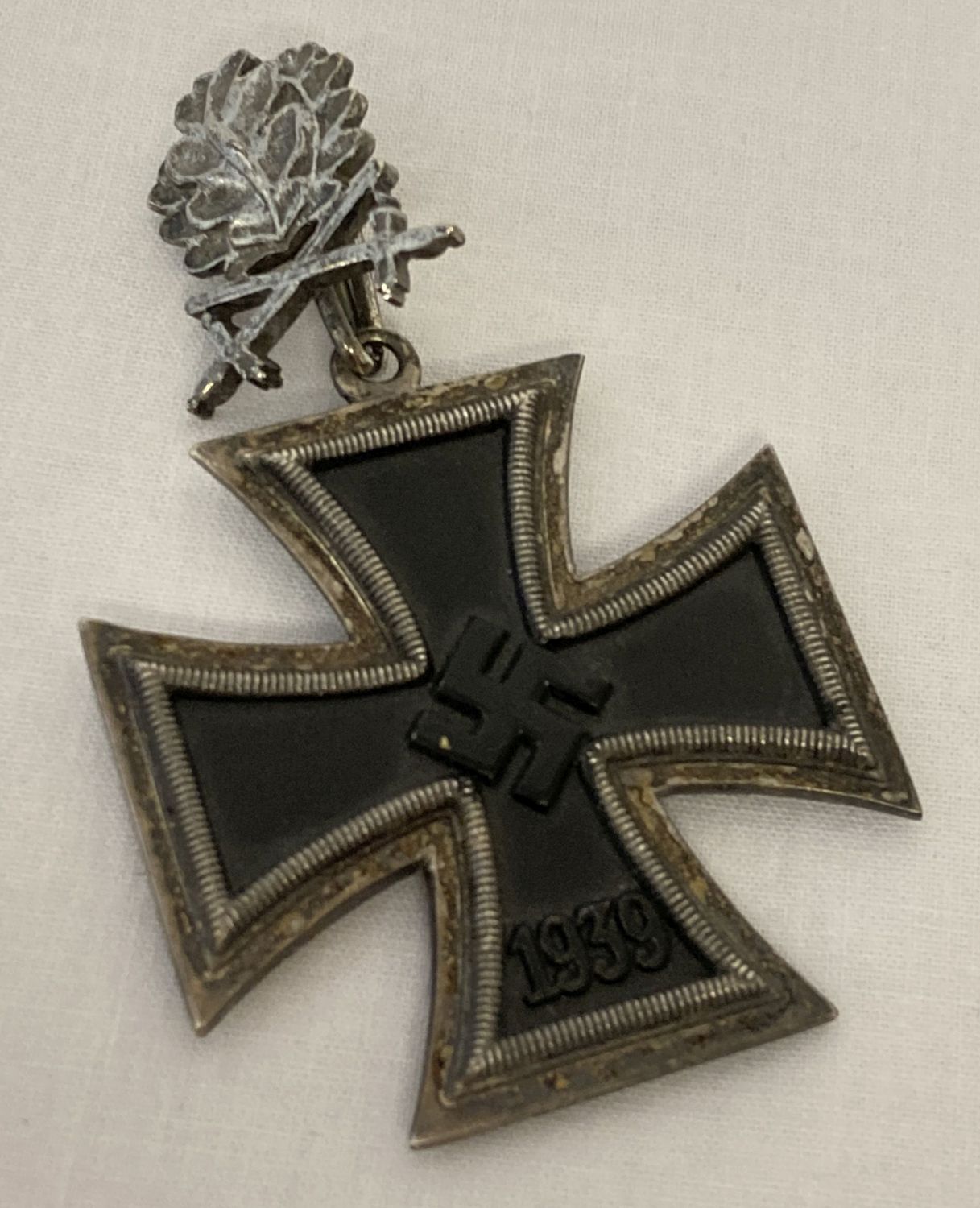 A WWII style Iron Cross with oak leaves and cross swords.