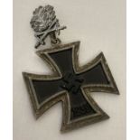 A WWII style Iron Cross with oak leaves and cross swords.