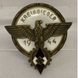 A WWII style Hitler Youth 1944 Kreissieger brass and enamel badge.