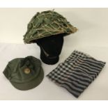 A Vietnam War era Viet Cong fibre helmet, cap and scarf.