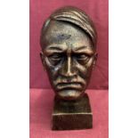 A cast metal bronzed figurine of Adolf Hitler's head.