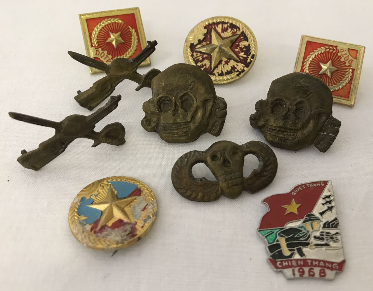 10 Vietnam War era badges to include screw back, pin back and lug fixings.