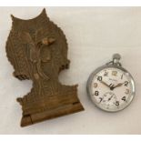 A WWII Helvetia British Military pocket watch with carved wooden folding watch stand.