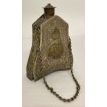 A Russian mixed metal gunpowder flask with highly decorated panels and carrying chain.