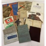 A collection of assorted Military related ephemera to include booklets, manuals and postcards.