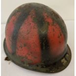 A US MIC steel helmet with black and red camo paint detail and M1 liner, circa late WWII/Korean War.