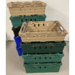 9 plastic supermarket stacking crates in various colours.