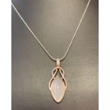 A silver fine snake chain with modern design drop pendant set with cloudy quartz.