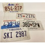 A collection of vintage plastic and aluminium American license plates.