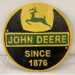 John Deere circular shaped painted cast iron wall plaque with fixing holes.