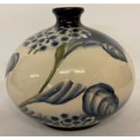 A large Moorcroft style ceramic short necked vase of bulbous form & blue and cream colouration.