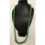 A 33" apple green jade beaded necklace, knotted between each bead.