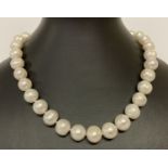 A 16" knotted large pearl necklace, with 14ct gold clasp. Each pearl approx. 1.4cm diameter.