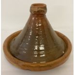 A large glazed terracotta Tagine.