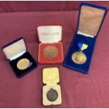 3 boxed medallions together with a boxed Rotary Club medal.