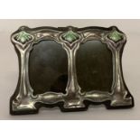 A small Art Nouveau style freestanding double picture frame with enamelled detail.