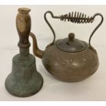 A vintage Art Nouveau style copper kettle with spiral metal handle.