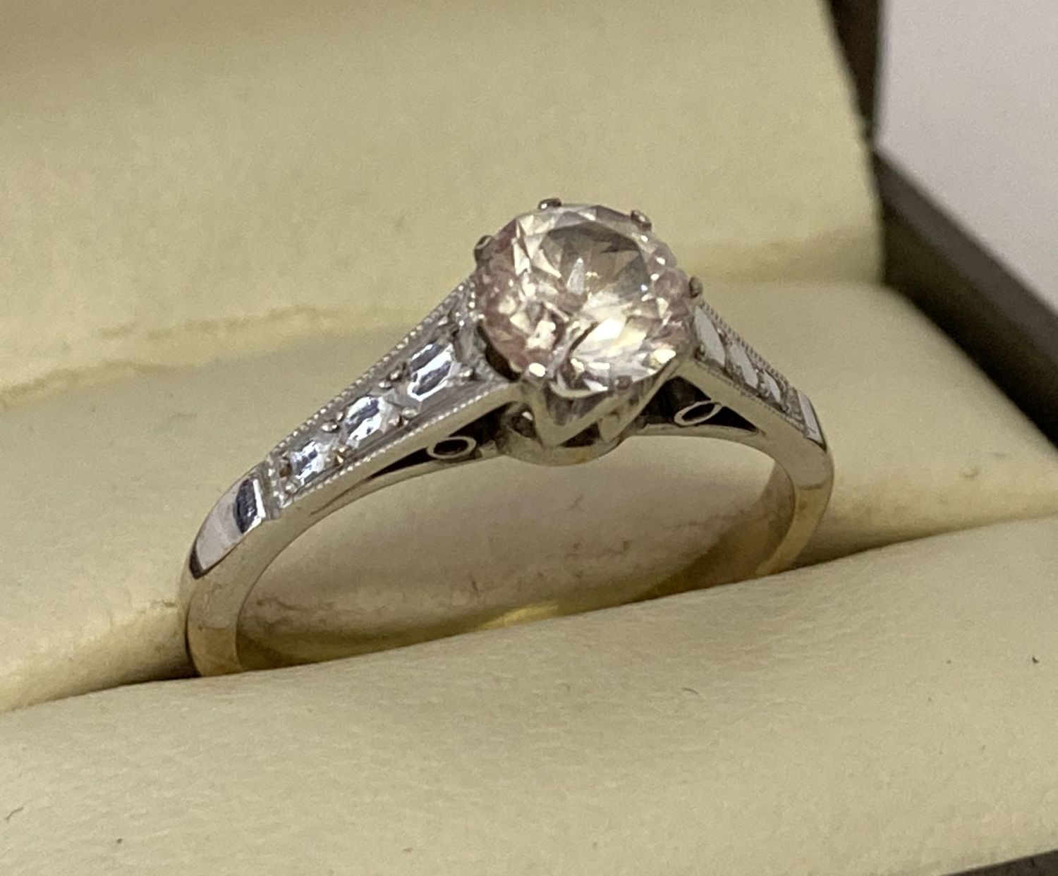 A vintage 9ct gold solitaire dress ring set with a central round cut clear stone.