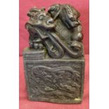 A large square shaped hollow bronze seal featuring a dragon turtle.