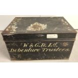 A vintage 2 handled black tin trunk with hand painted detail.