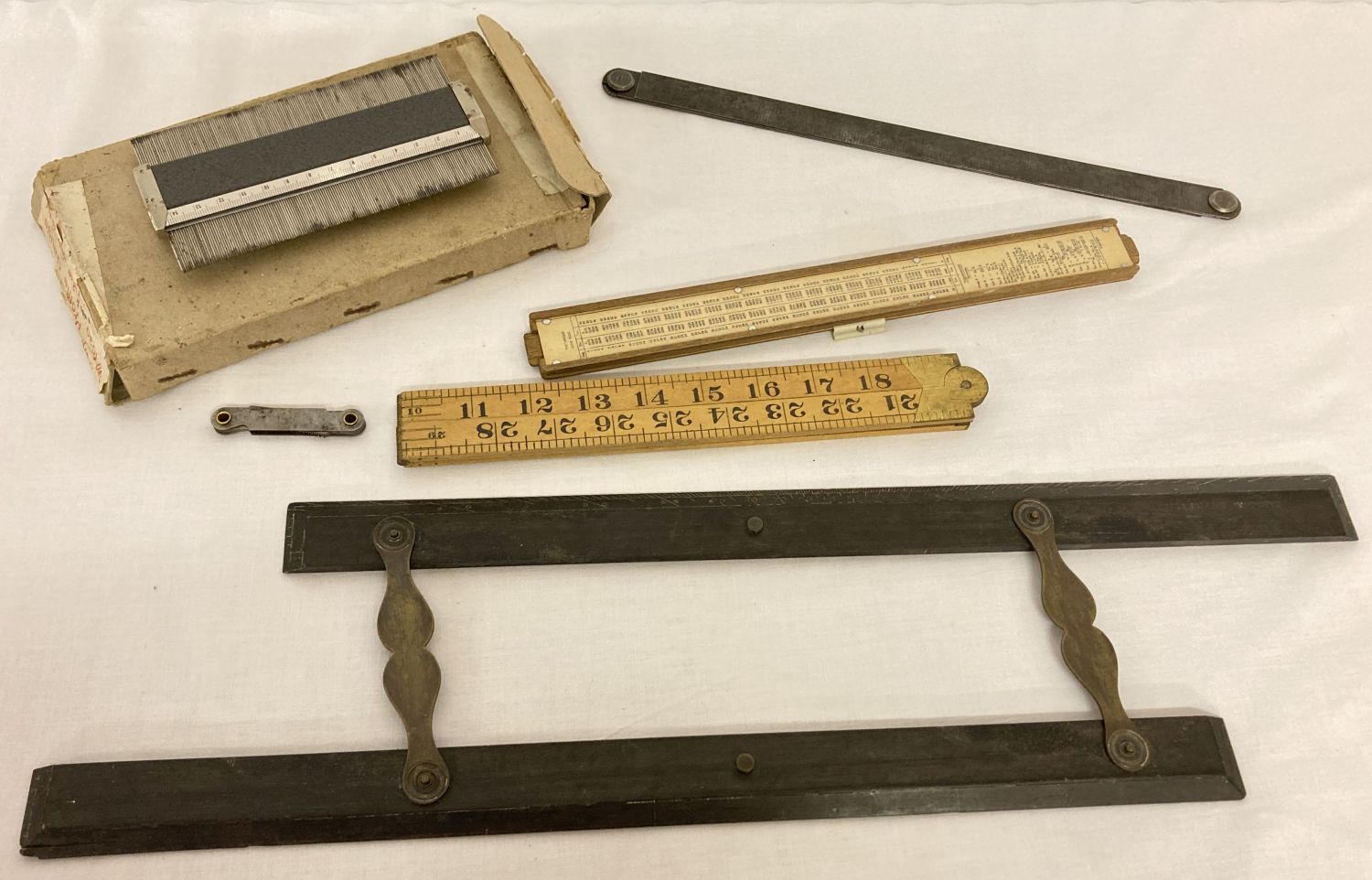 A collection of vintage rulers and measures.
