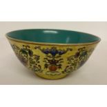 A large Chinese porcelain Famille jaune tea bowl with blue/green glaze to inner bowl.