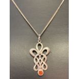 A silver fine curb chain with an Art Nouveau style drop pendant set with a small round carnelian.