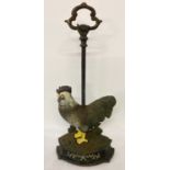A painted cast iron cockerel doorstop with carry handle.