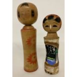 2 small vintage wooden Japanese Kakashi dolls, one signed to underside.