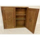 A wooden wall hanging cigar cabinet with interior shelves and inlay detail to front.