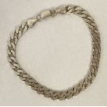 A silver curb chain bracelet with lobster style clasp. Marked 925, scales and makers initials.