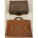 A vintage small leather suitcase together with a leather briefcase with brass fixing and buckles.