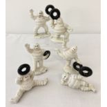 A collection of 6 small painted cast metal Michelin men figures, carrying tyres.