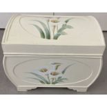 A cream painted dome topped storage box decorated with calla lilies, with carry handles.