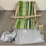 A pair of garden hanging hammock seats with green stripe decoration.